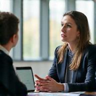 Project manager consulting with client in office