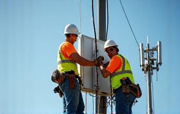 Construction crew installing base station hardware